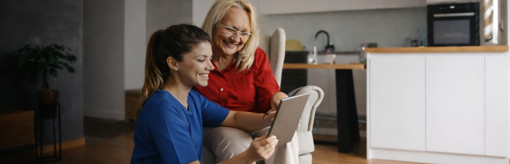 Caregiver and client sharing a moment together—companionship and engagement at home.